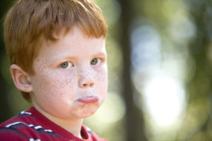 Sad child with red hair